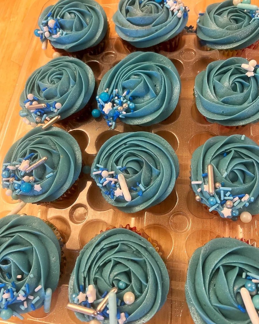 A tray of blue rosette cupcakes